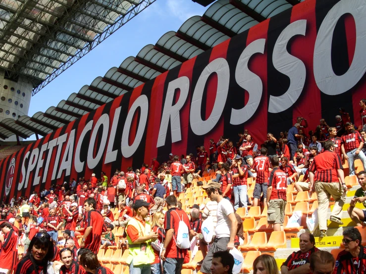 fans at the stadium stand near the soccer logo