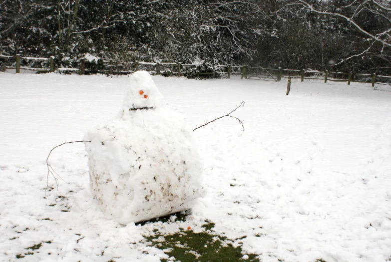 a snowman made out of a stone in a field