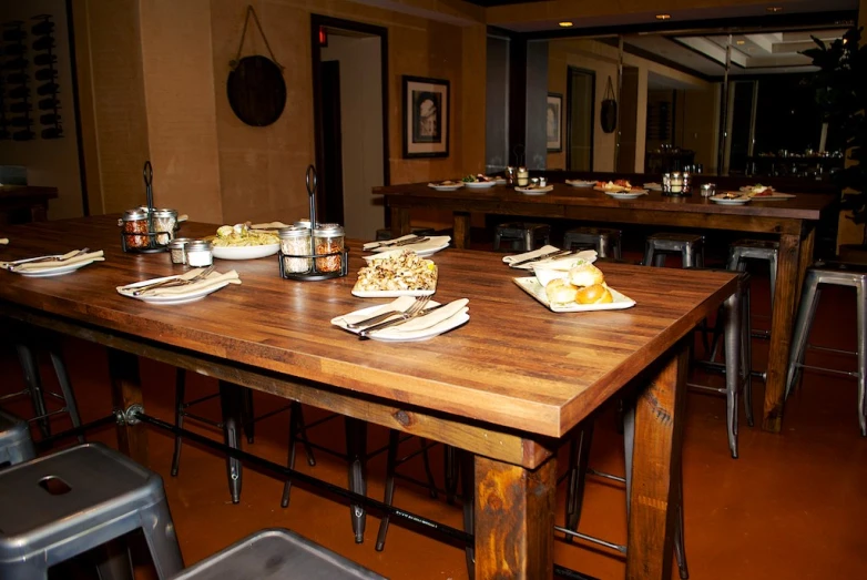 an old table full of beer, food and food dishes