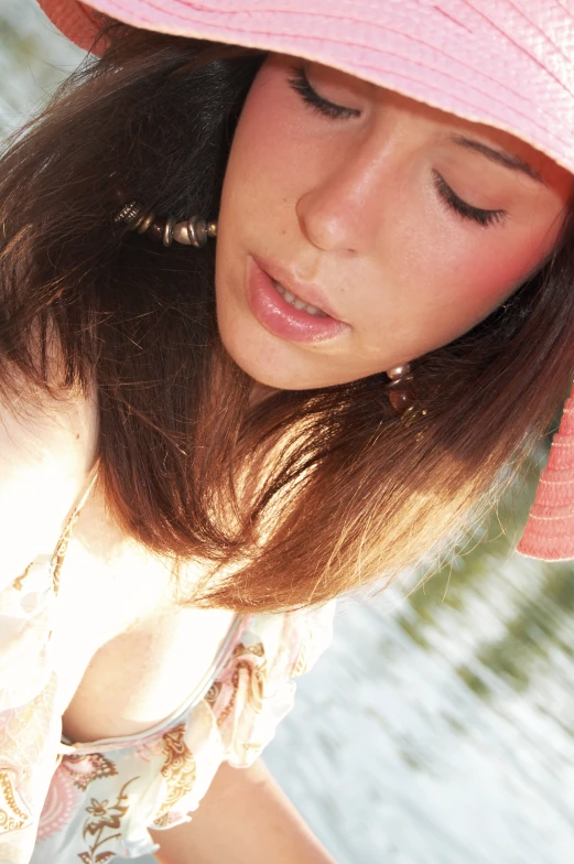 a girl with long hair in a pink hat