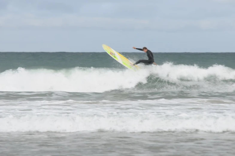 there is a man riding a wave on a surfboard