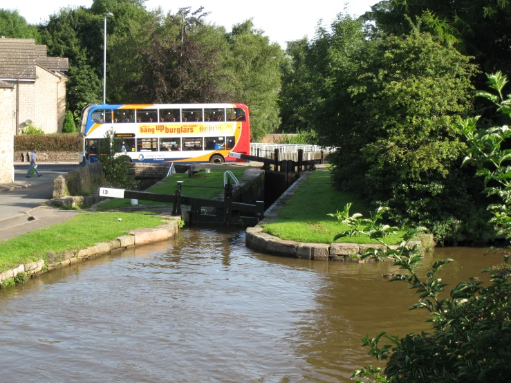 a double decker bus drives over a bridge