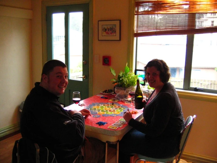 two people are having fun at the dinner table