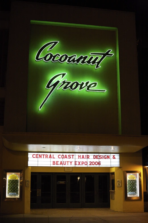 neon sign on building for the central coast hair salon