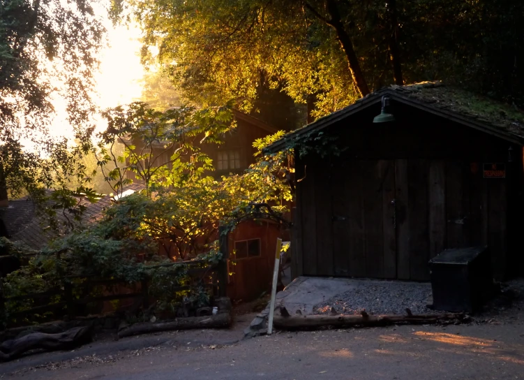 a house with no roof next to trees and dirt