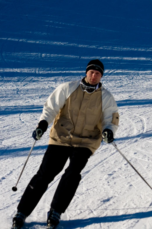 a man wearing skis with poles posing for the camera