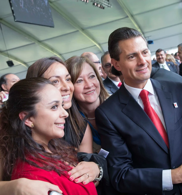 a man in a suit is surrounded by people