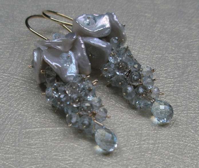 two pieces of glass that are set in earrings