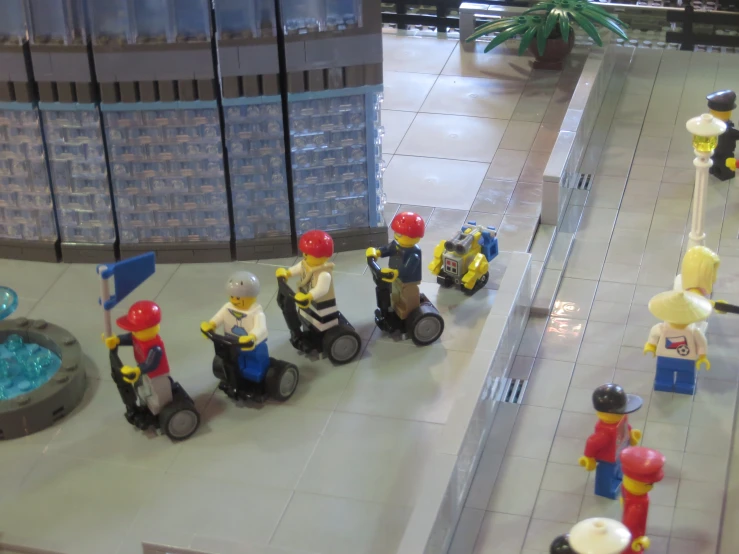 lego men with yellow and red helmets on minibikes