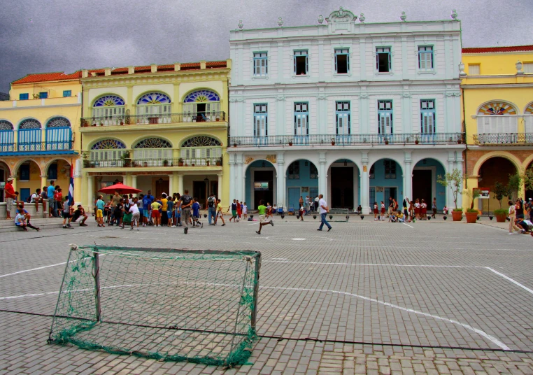a group of people playing basketball in a town square
