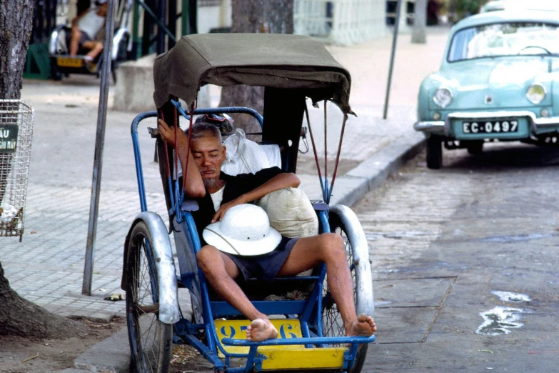 two men in a cart pulling a woman in it