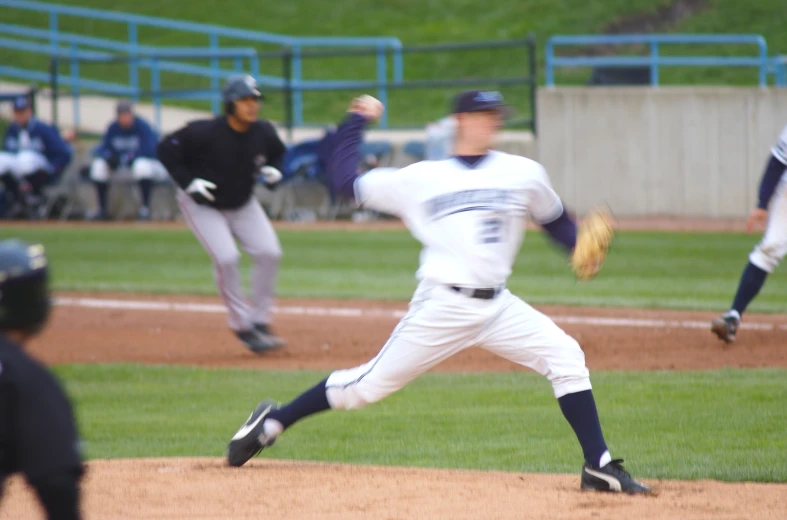 a baseball pitcher winding up to throw the ball