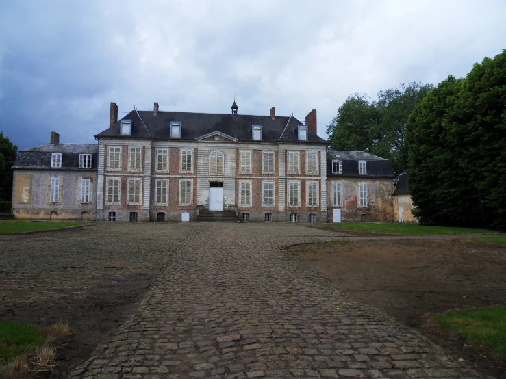 a big stone street with a building in front of it