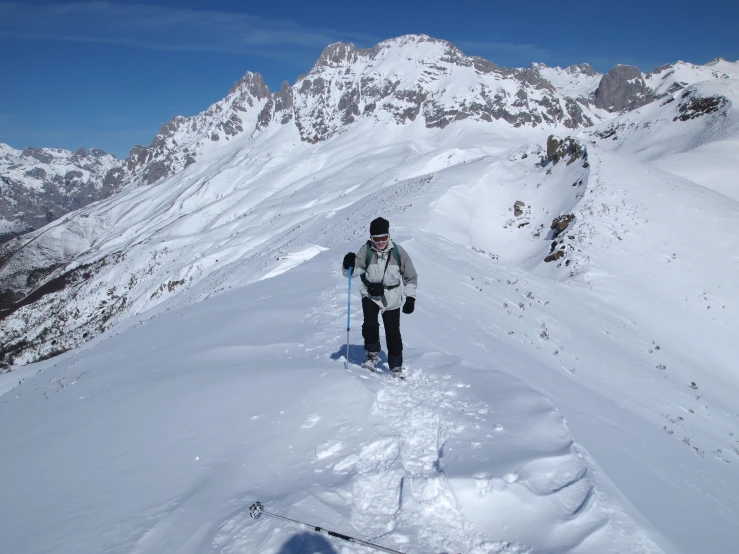 person skis down the side of the mountain side