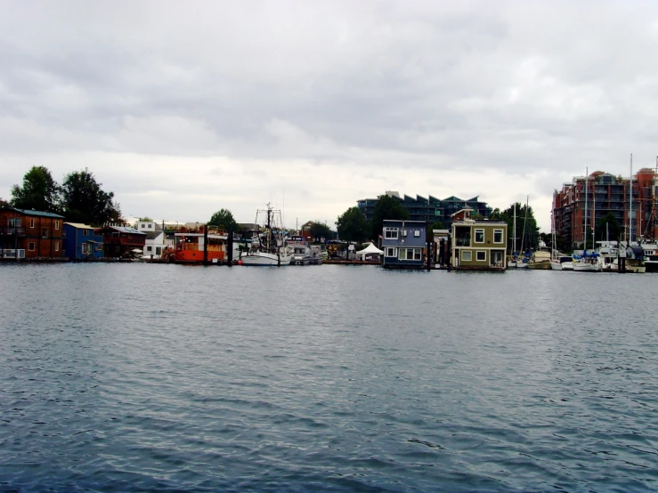 the waterfront is lined with houses and large sailboats