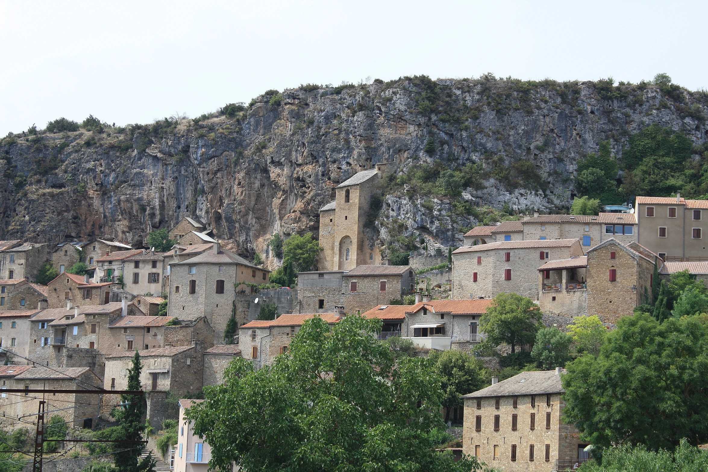 old buildings with an overhang stand on a hillside