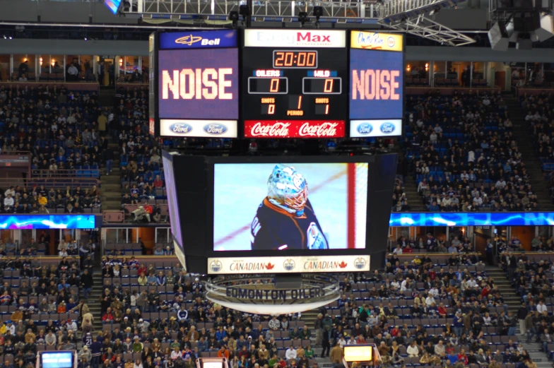 a large screen is sitting in a hockey stadium