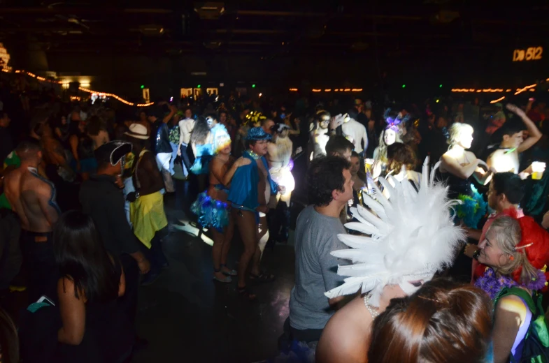 a crowd of people in costumes at night