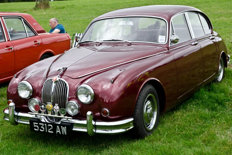 antique cars parked on grass near each other