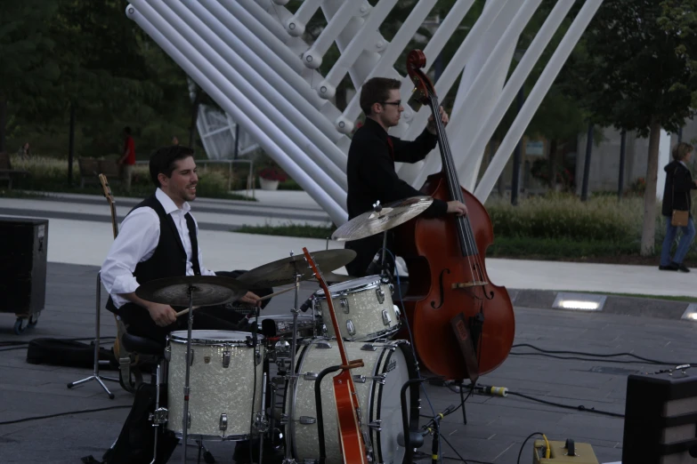 men playing instruments on a city street