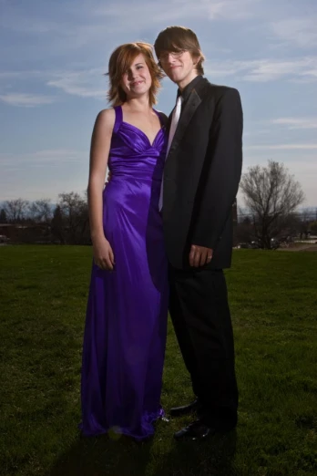 a man and a woman are in prom dresses