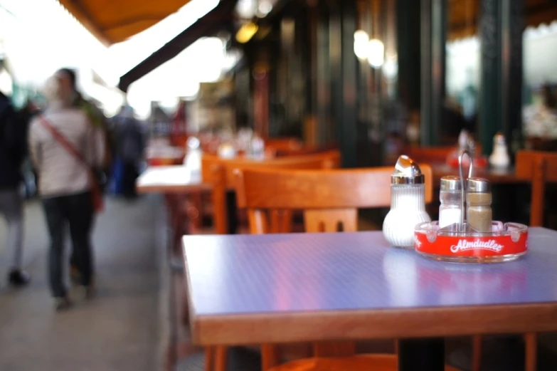 an outdoor cafe is shown with many tables