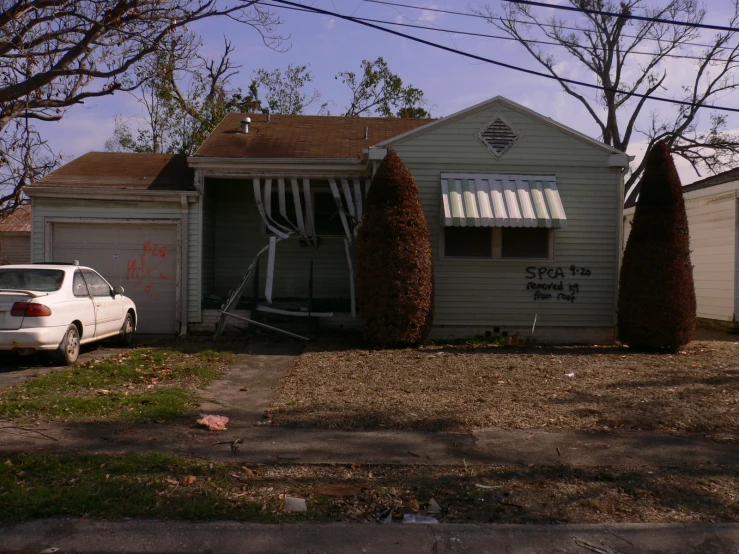 an upside down house with cars parked outside