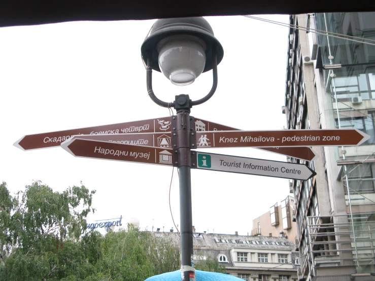 an urban street sign with a lamp post