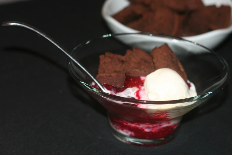 a dessert in a glass dish with ice cream and some sort of fruit