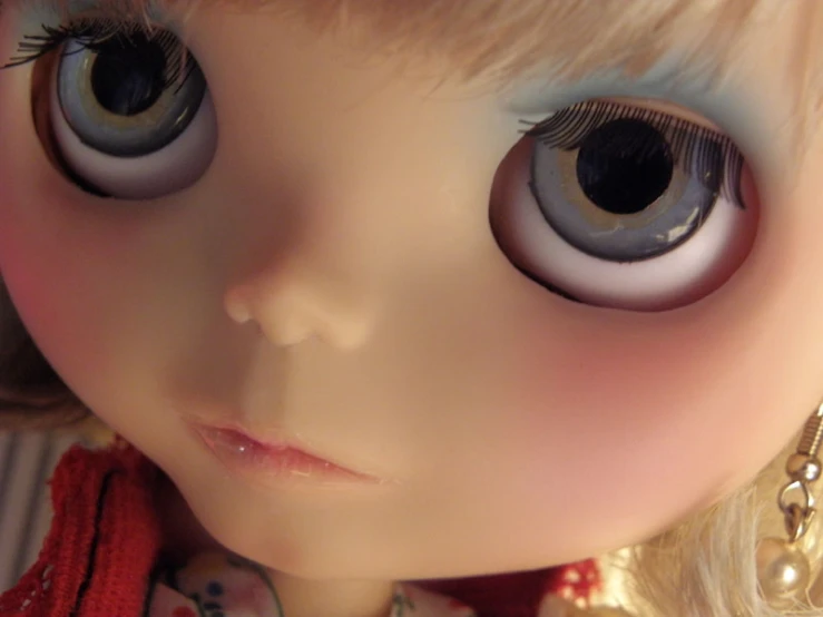doll eyes are visible with a dress shirt around their neck