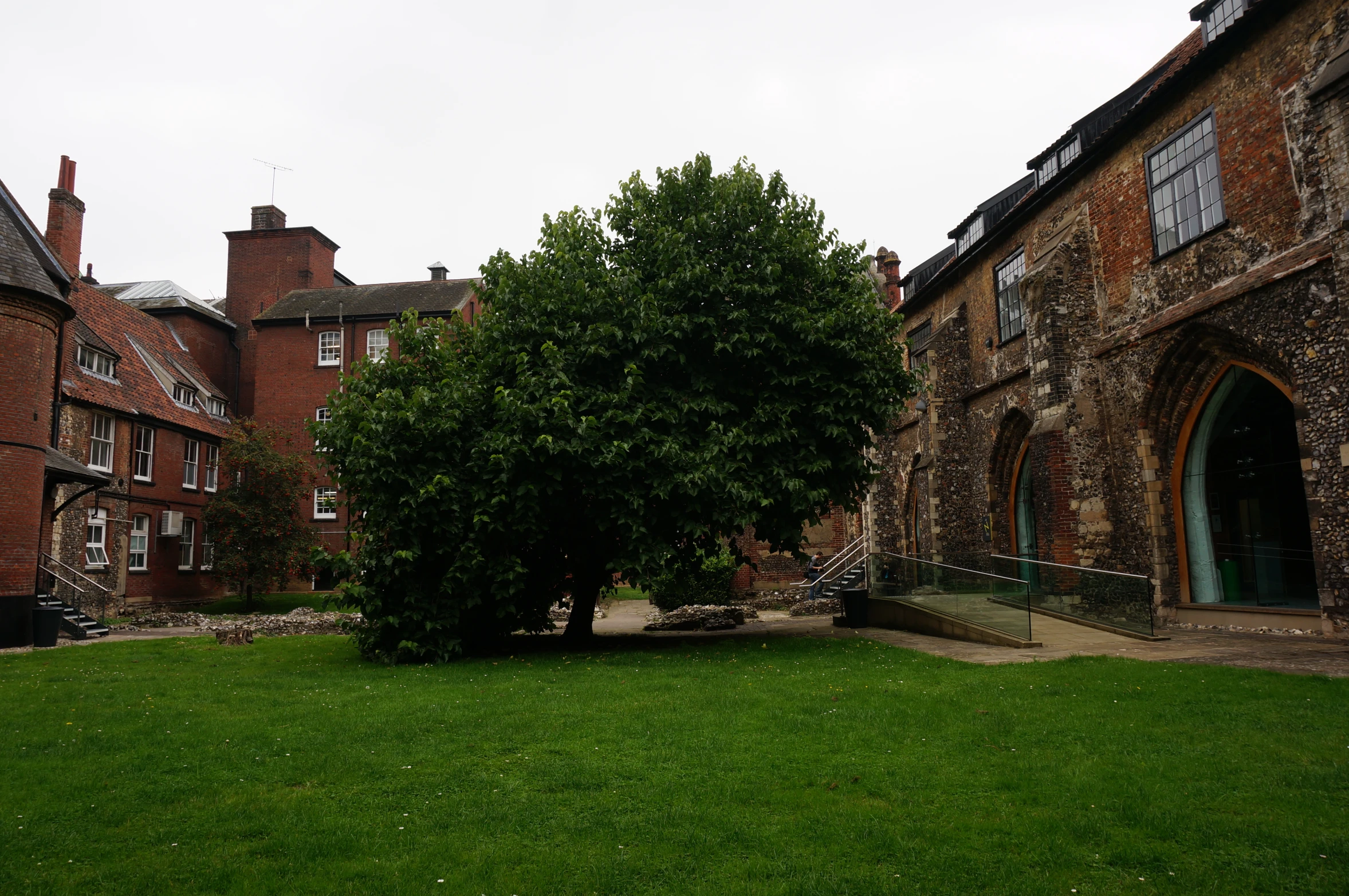 the front yard of an old building and large green lawn