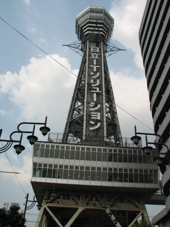 a tall clock tower sitting below a partly cloudy sky