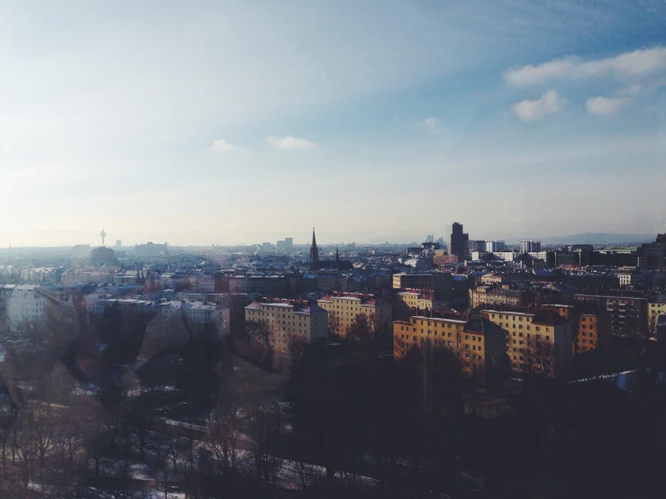 a picture looking out over a city with trees and buildings