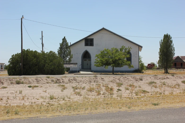 an empty church is shown in the desert