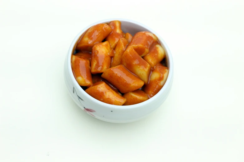 orange colored cooked food on a white table