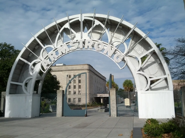 an arched white iron entrance to the city