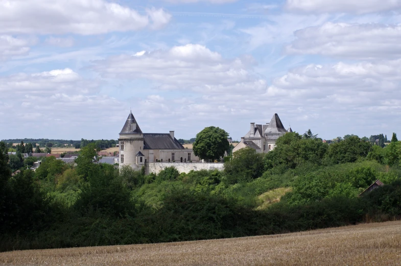a picture taken from the hill side with a castle in the background