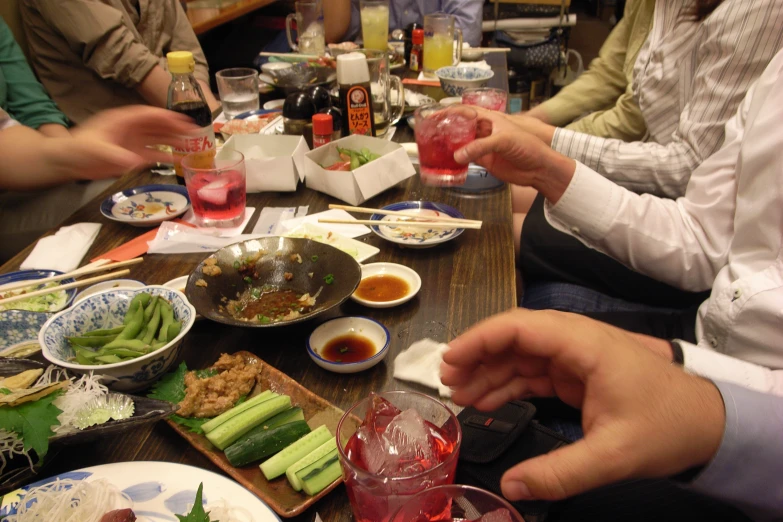 a group of people sitting around a table eating