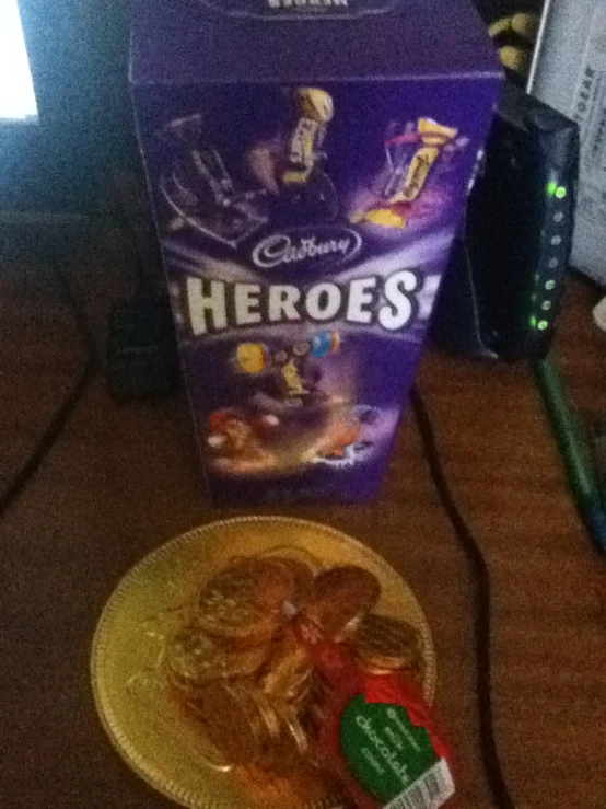 a box of cookies next to a plate of chocolates