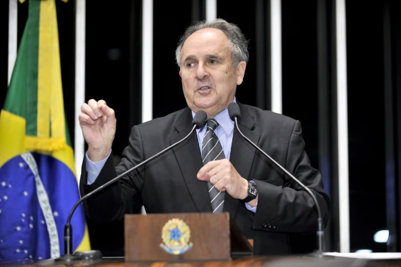 a man wearing a suit making a speech