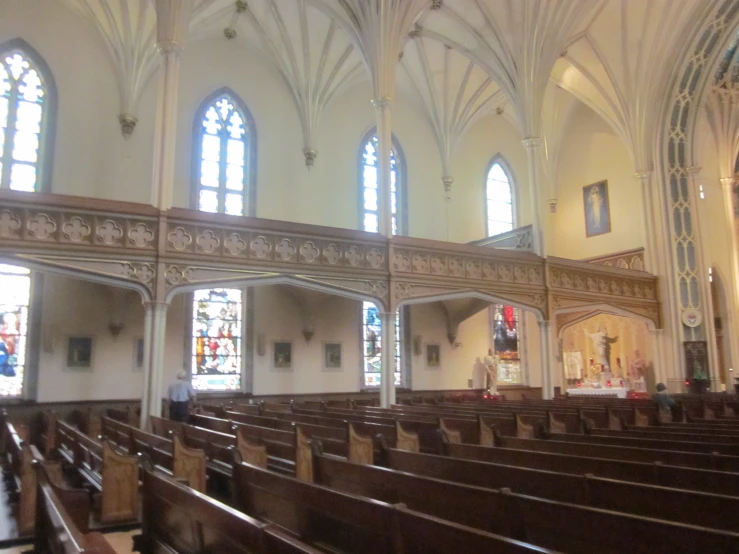 a cathedral with lots of pews and stained glass windows