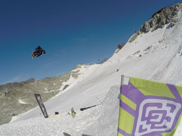 a snowboarder is in the air performing a stunt