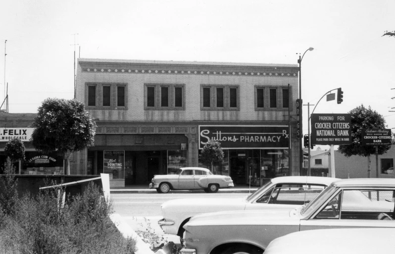 cars are parked in front of a liquor building