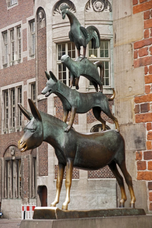 an outdoor statue of some animals, some birds and one ram