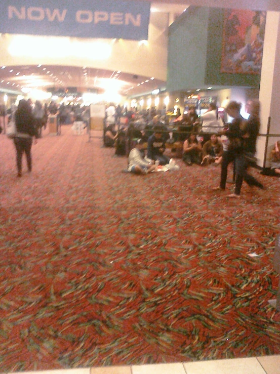 many people in a convention hall are sitting in chairs