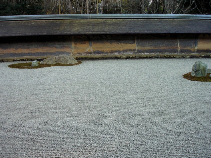 a stone wall that is very close to grass