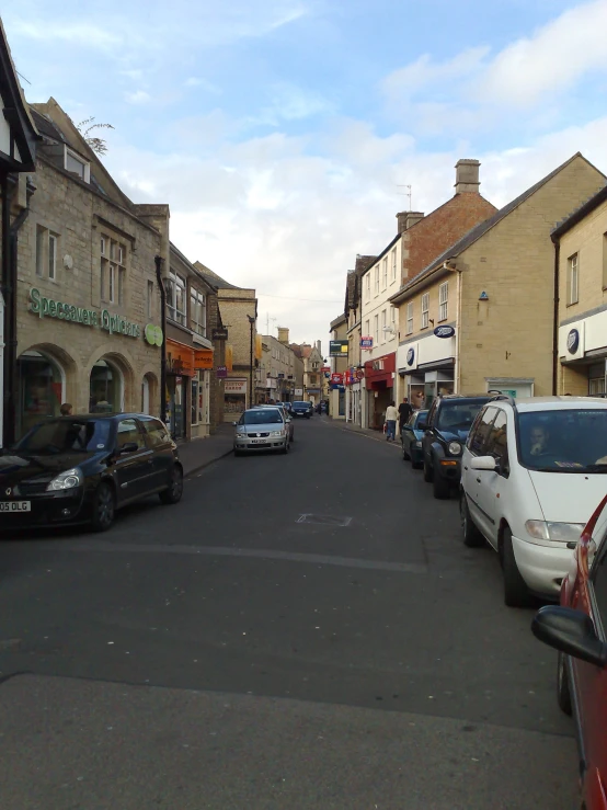 a city street that has cars parked on both sides