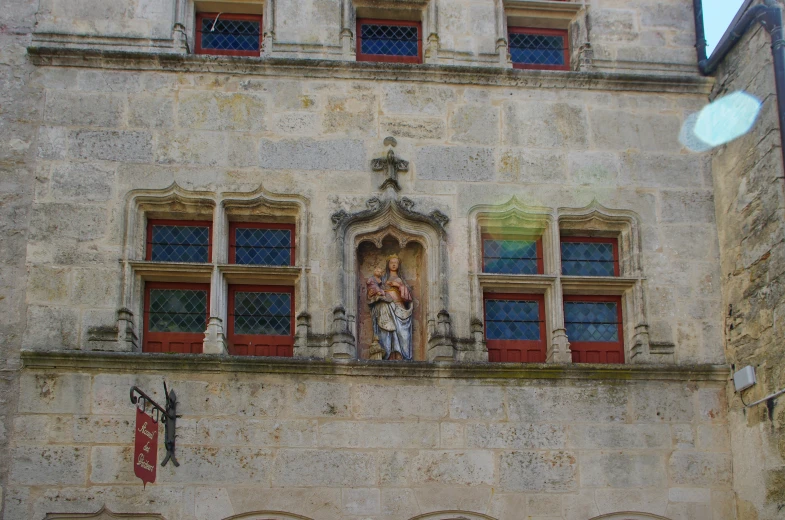 an old building with a statue on the front of it