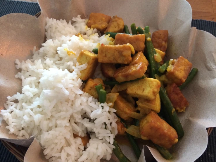 a close up of a plate of food with rice and chicken