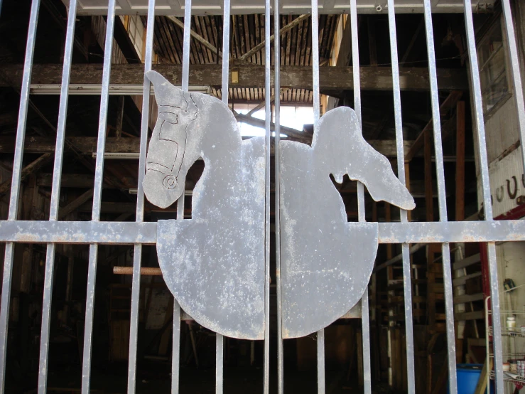 an old iron gate with a metal horse on it